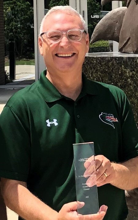 Frank Messina holding his award.