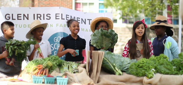 Elementary school students with farm produce. 