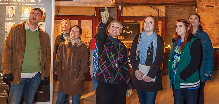 UAB history professor and historic preservation expert Pamela Sterne King (center) leads students on a tour of renovations at Birmingham's Lyric Theatre. Photo by Art Meripol. 