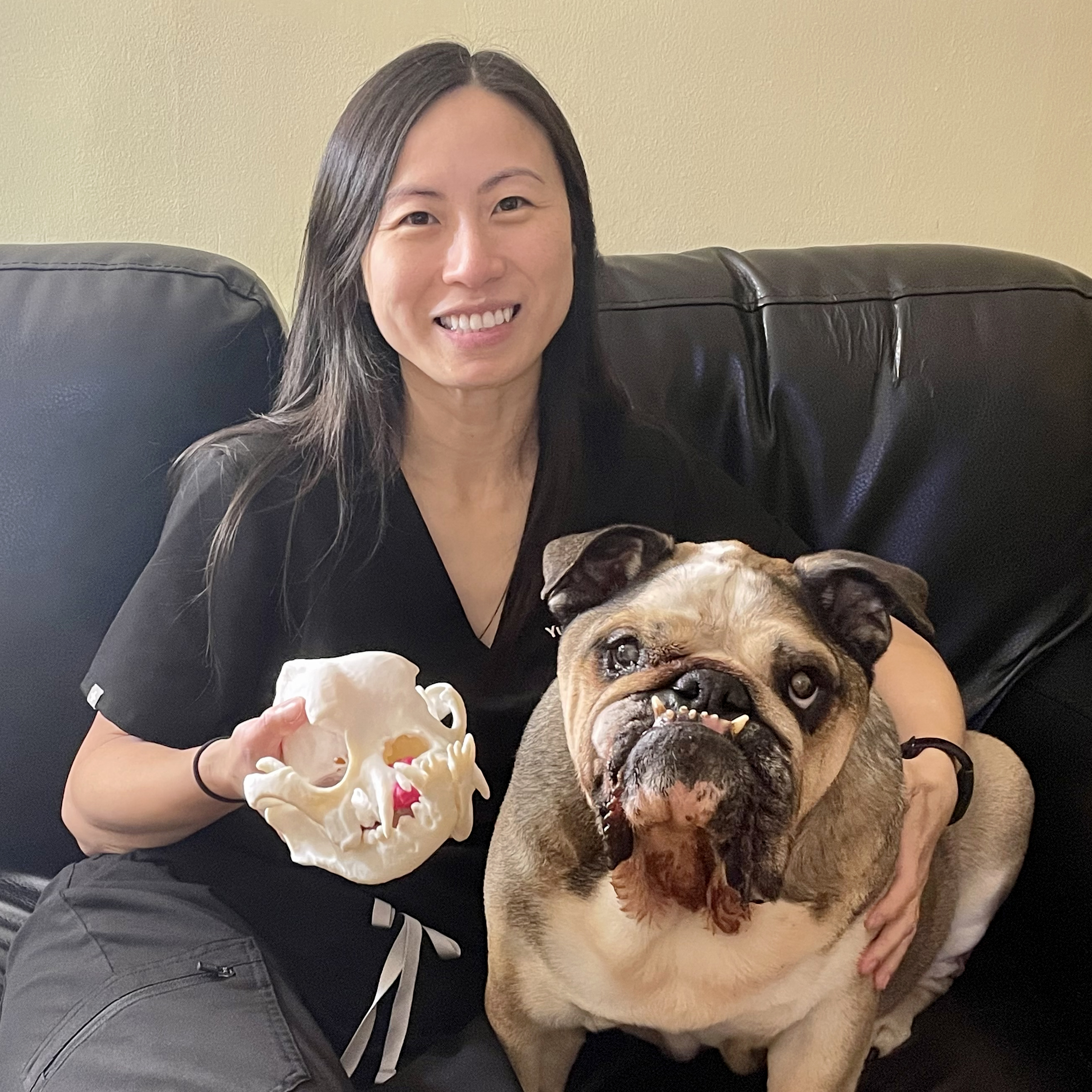 Yu-Hui Huang holding a 3D printed model of her dog's skull and tumor, which she printed for a veterinary surgeon to assist with his surgery