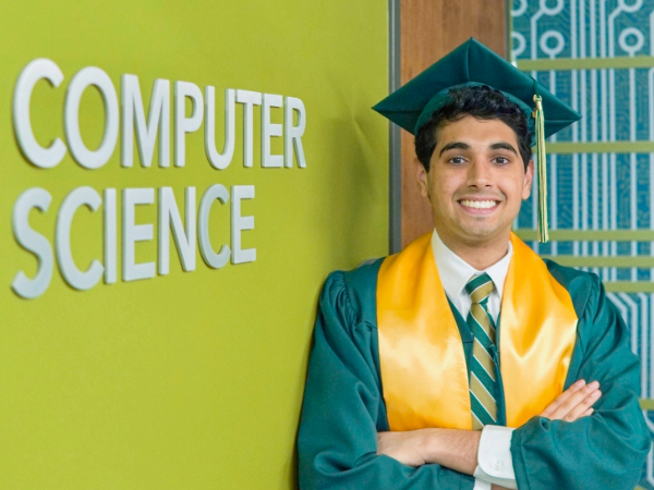 Rizwan Khan next to Computer Science sign
