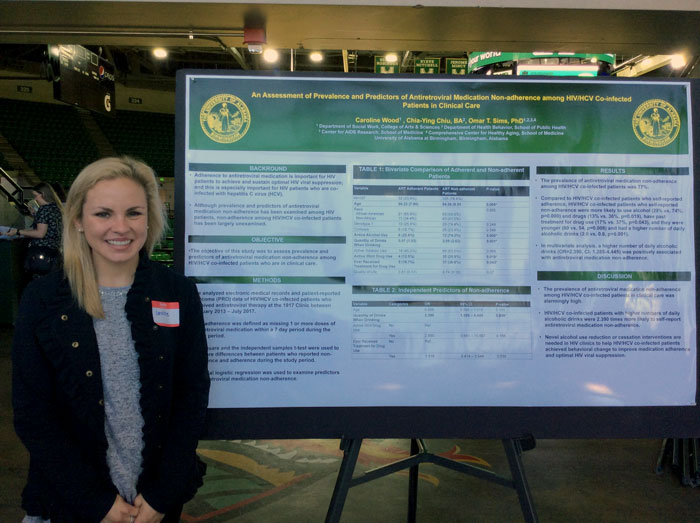 Caroline Wood in front of her poster/ 