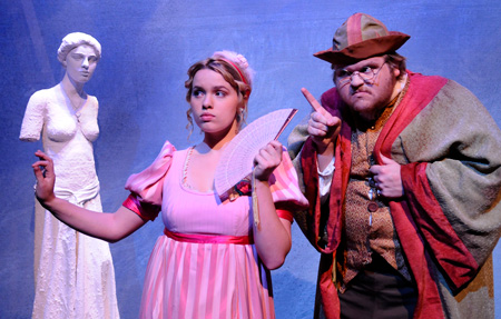 Two theatre UAB students performing on stage in front of a armless statue.