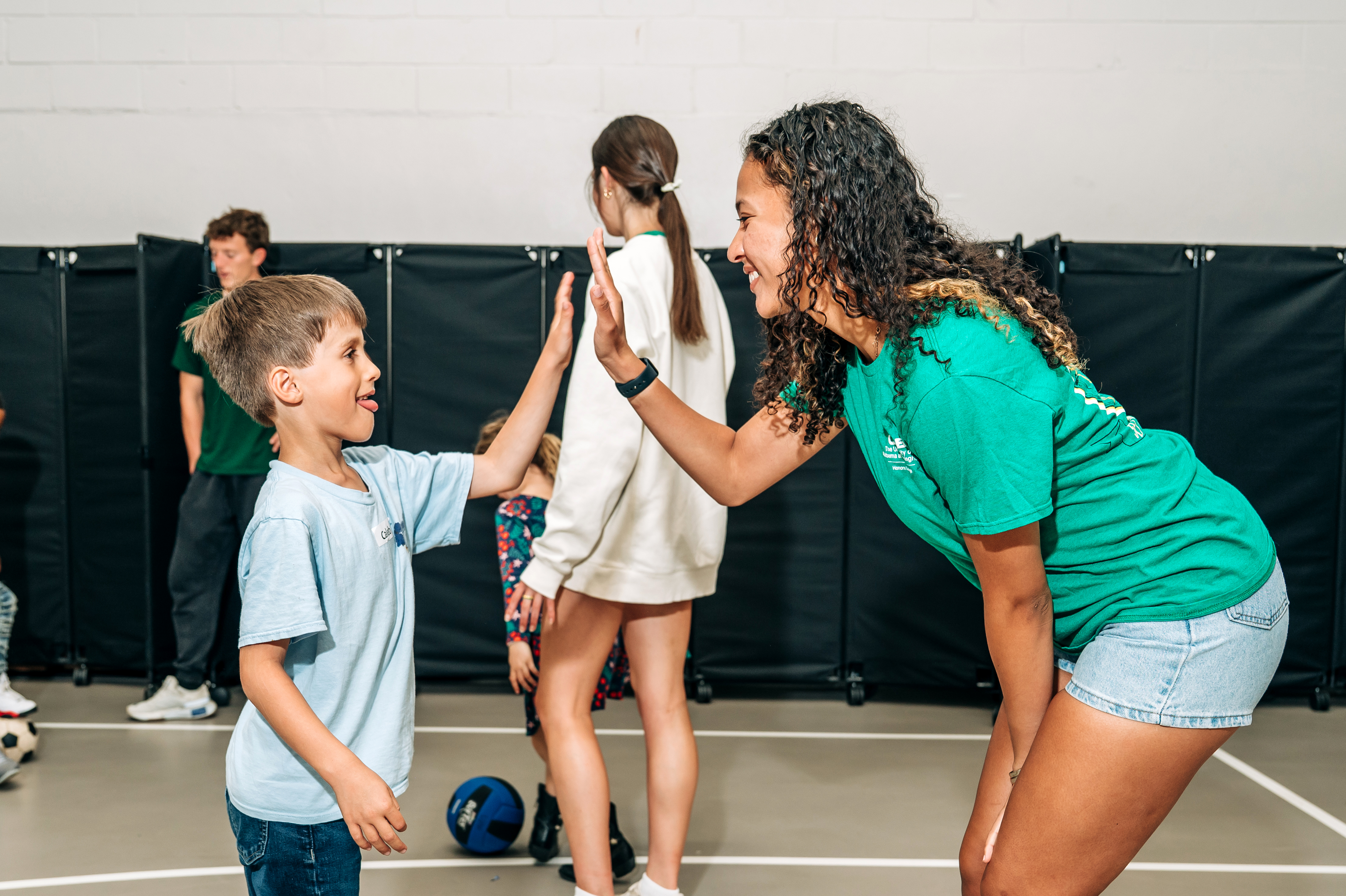 A kinesiology student interacts with a local elementary student at the Avondale Samaritan Place Move It after-school program.
