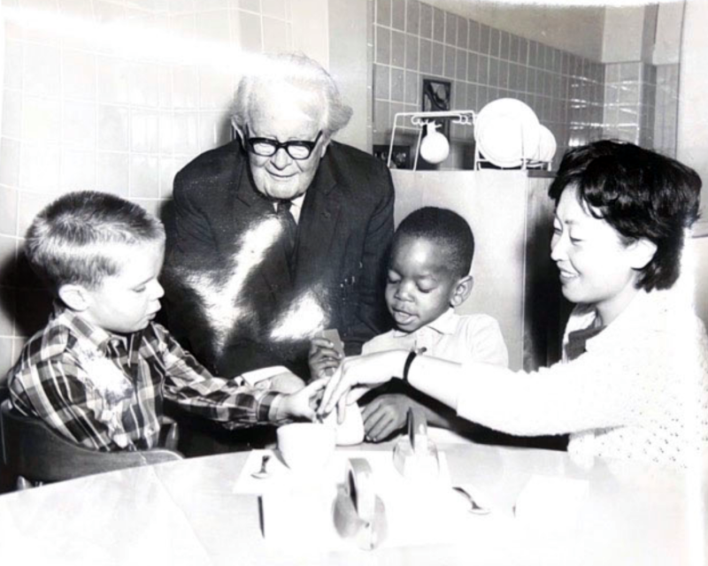Black & white photo of a young Kamii with two young students and unidentified elderly male.