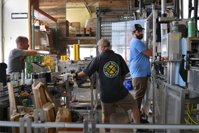 DeBoer working in his brewery with staff.