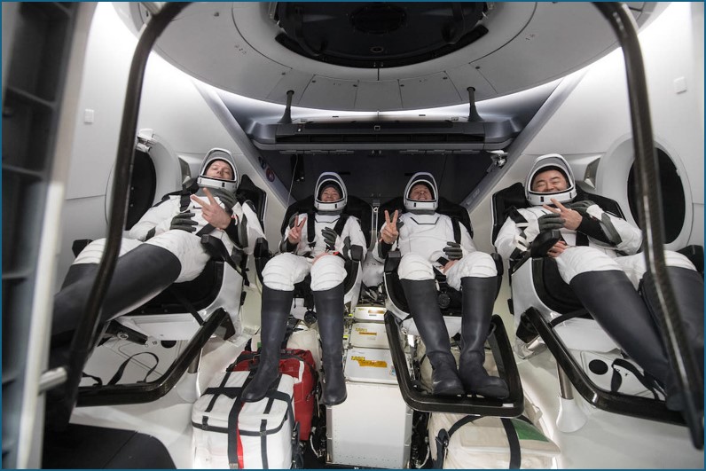 Astronauts aboard their spacecraft, returning to Earth with UAB-built systems on board.