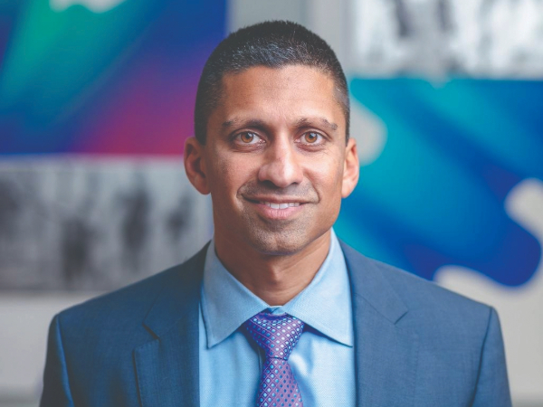 Irfan Asif MD in front of a colorful background