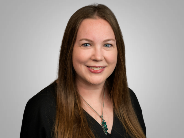 Professional woman in black top with black necklace