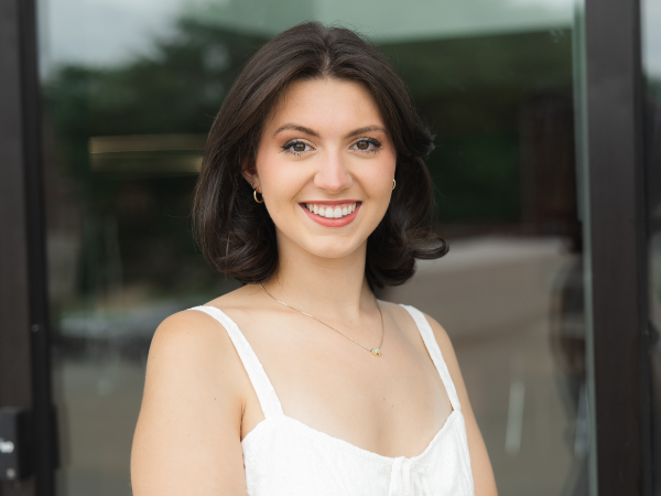 Smiling woman in white dress 