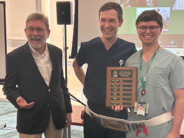Walt Johnson, M.D., David Wolff, M.D., and Daniel Cooper, M.D. with the Walt "The Rock" Johnson Award
