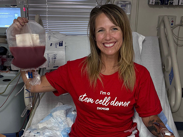 Jenn Coker, Ph.D. in a hospital bed donating stem cells for research