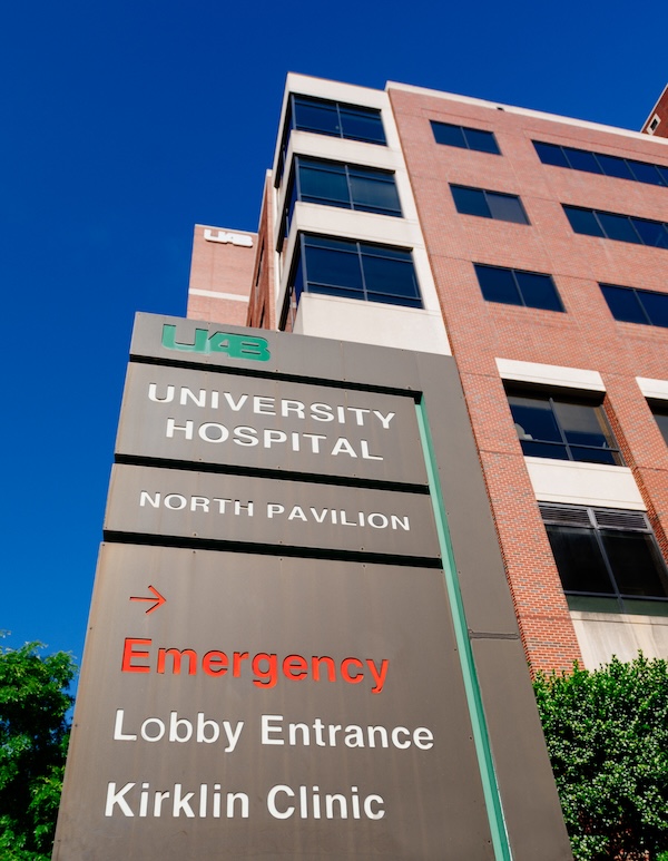 Close-up of the "UAB University Hospital North Pavilion" sign, which also shows the direction for Emergency, Lobby Entrance, and Kirklin Clinic" in front of the North Pavilion of UAB Hospital, April 2020.