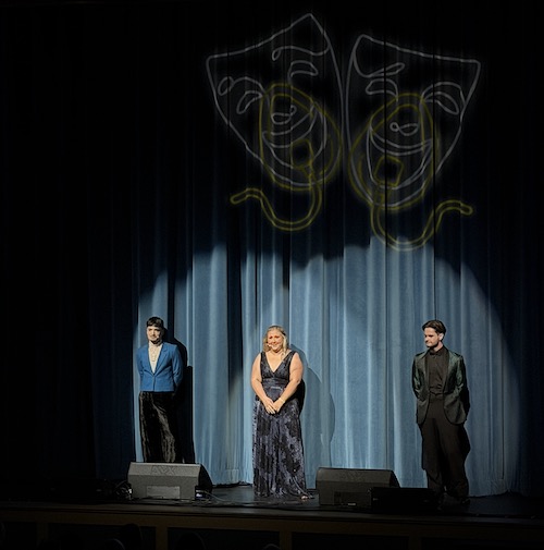 Three hosts of Best Medicine Show on stage in front of curtain.