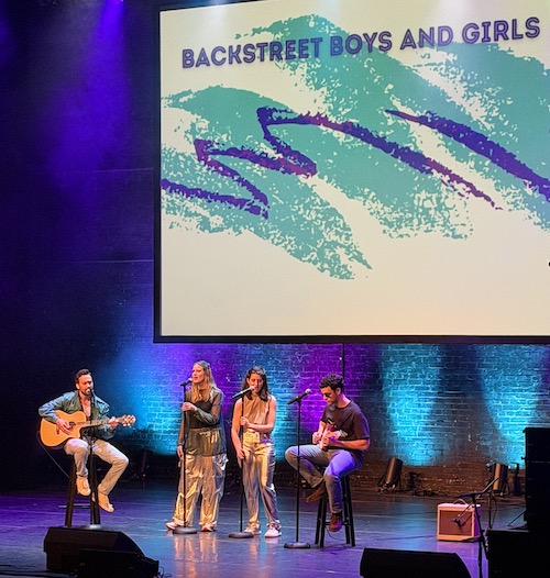 A group of medical students performing a song on stage.