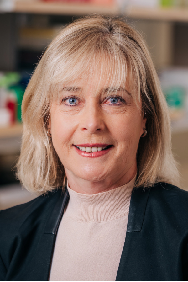 Inga Kadisha, Ph.D., stands in front of supply shelves.