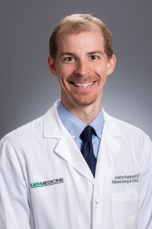 Jonathan Kalehoff, M.D., stands in front of a gray background