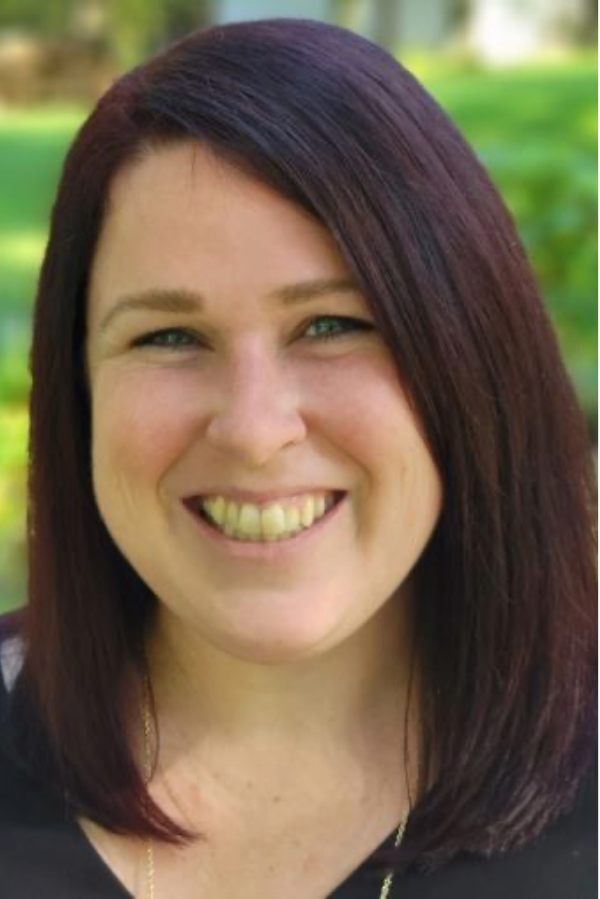 Kirstie Cummings, Ph.D., stands outdoors.