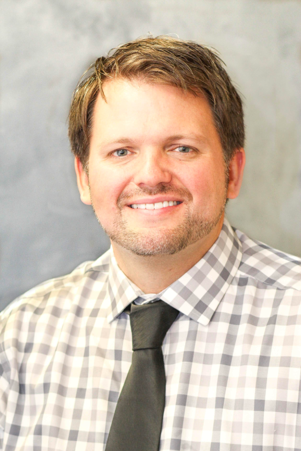 Matthew Clark, M.D., stands in front of a textured background.