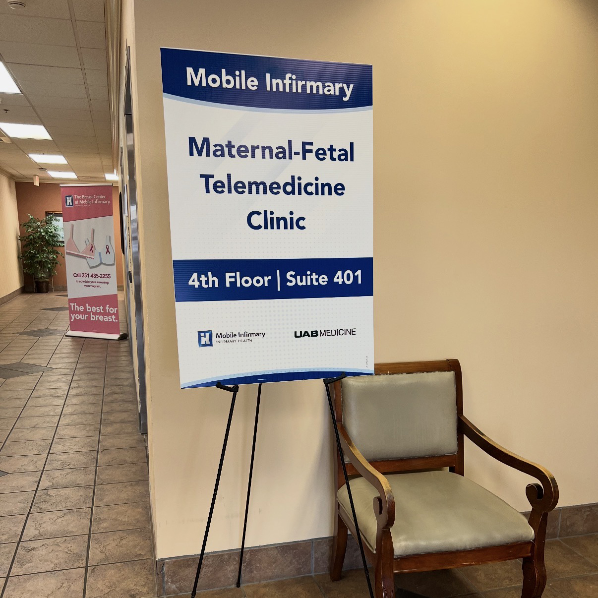 A medical facility hallway with a sign for the Maternal-Fetal Telemedicine Clinic at Mobile Infirmary.