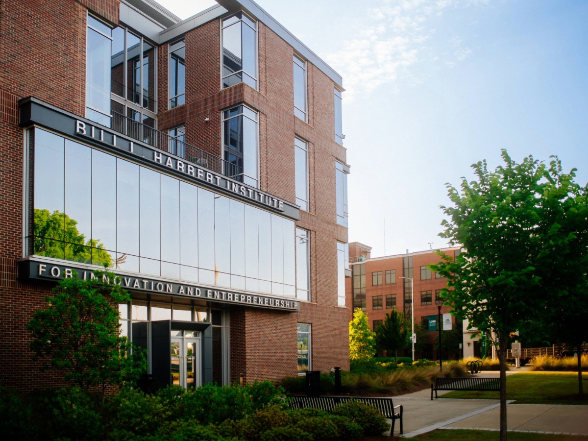 Building signage that reads "Bill L. Harbert Institute for Innovation and Entrepreneurship" around a large window outside of the Collat School of Business, May 2022. 