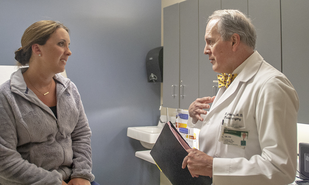 Professor in the Division of Plastic Surgery Dr. R. Jobe Fix talks with a patient at The Kirklin Clinic.