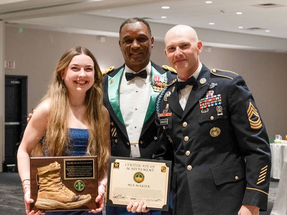 Mia Martin pictured with retired Lt. Col. Jamaine Williams (center) and Master Sgt. Edsell Bankston (right) at the Blazer Battalion Military Ball