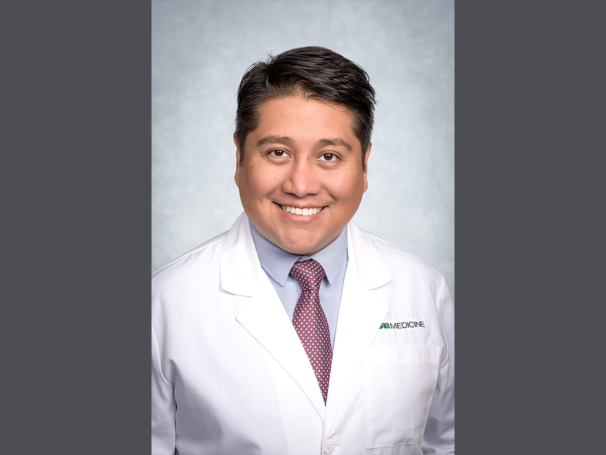 Headshot of Ariel Salas in white coat.
