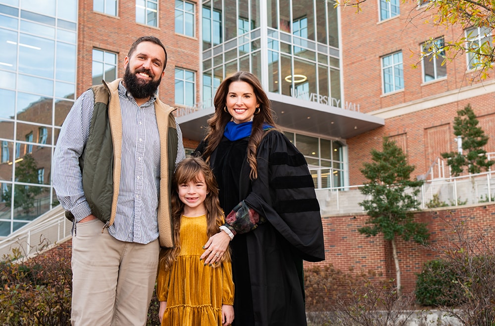 Brittany Nicole Stewart and her family pose in front of University Hall