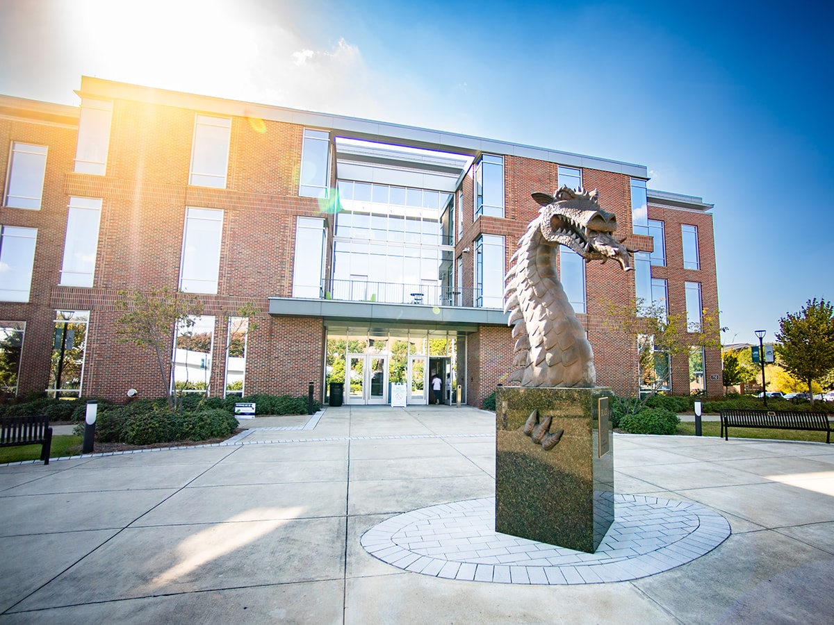 Exterior of the Collat School of Business with dragon sculpture