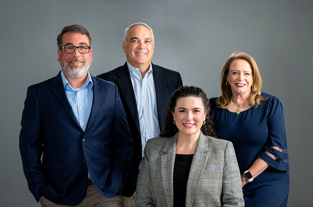 University Compliance leadership team members Jereme Logan, James Erwin, Courtney Champion and Audrey Fortier pose for a portrait in the UAB photo studio