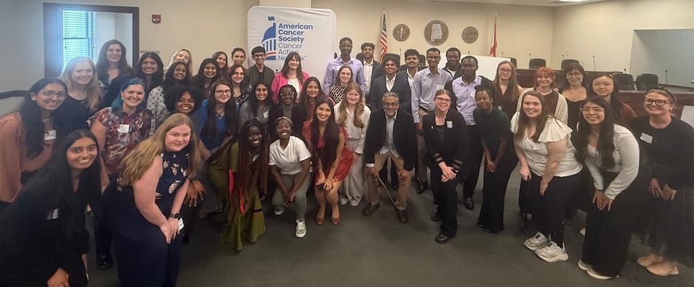 Student scientists and faculty members pose together for group photo inside State Capitol.