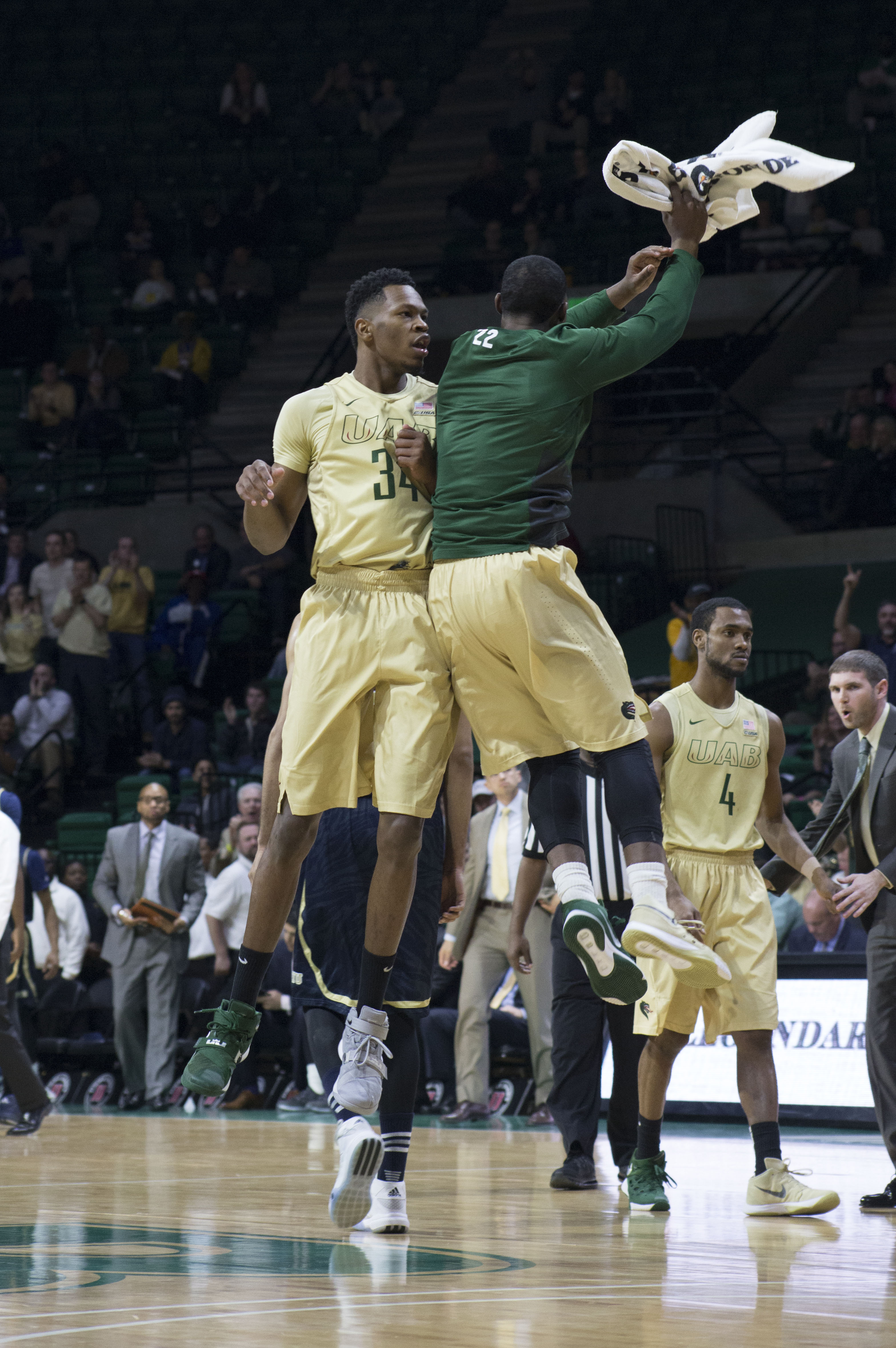 Junior guard Tyler Madison celebrates with William "Haha" Lee during an FIU timeout Thursday night. (Photo by Leonardo Carrubba).