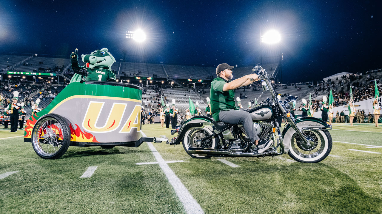 Cody Sellers pulls Blaze in his motorcycle chariot at the first football game of the 2025 season.