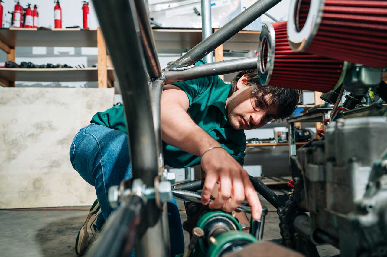 Hollingsworth works on the engine of a student-built Baja car.